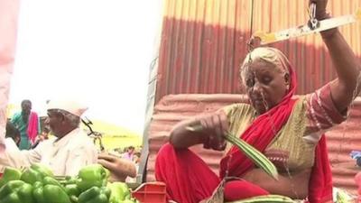 Woman weighing vegetables