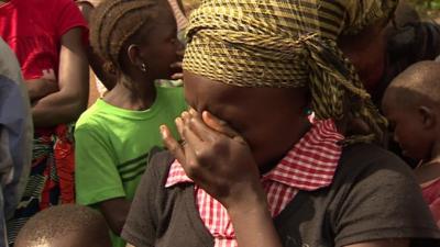 A young girl in Sierra Leone mourns the death of her parents from Ebola