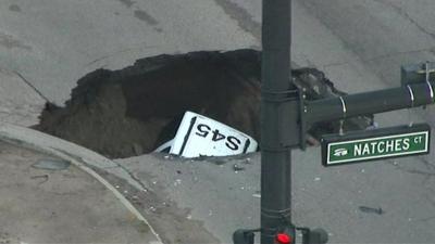 aerial view of car in sinkhole