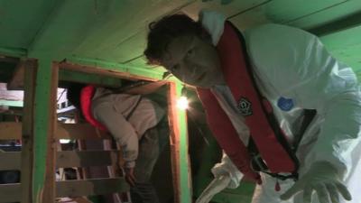 Gabriel Gatehouse below deck on the migrant boat