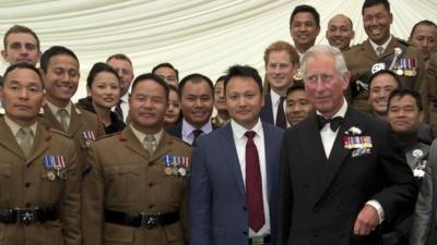 Princes Charles and Harry with a group of soldiers from the Brigade of Gurkhas