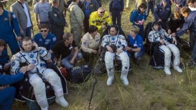 Nasa astronaut Terry Virts, Russian cosmonaut Anton Shkaplerov and European Space Agency astronaut Samantha Cristoforetti rest after landing