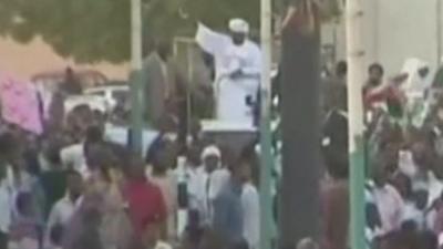 Bashir waving to a crowd