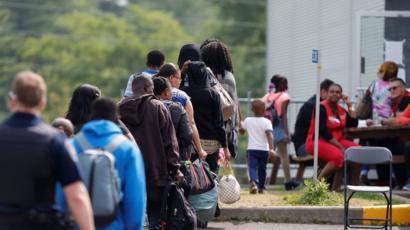 Asylum seekers wait to be processed at the Quebec-New York crossing