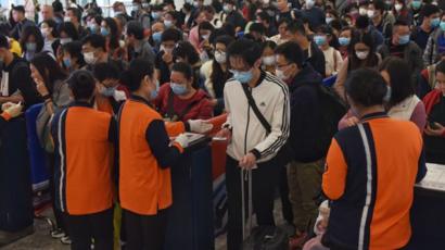 Des personnes masquées font la queue à l'aéroport de Hong Kong