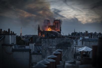Flames and smoke are seen billowing from Notre-Dame's roof