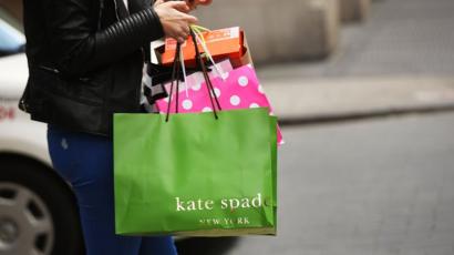 Kate Spade shopping bag held by a shopper