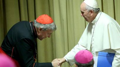 Cardinal Pell bows as he shakes hands with Pope Francis at a session of Synod at the Vatican in 2015