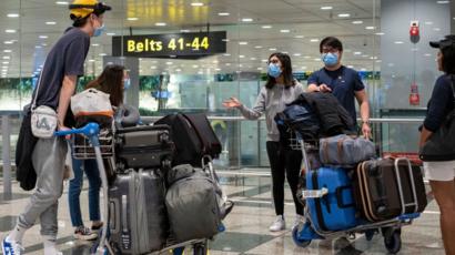 Travellers wearing face masks