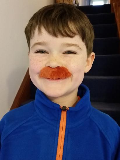 Boy wearing a moustache
