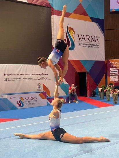 Two gymnasts holding a pose