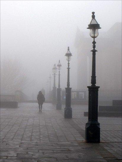 People walking through mist
