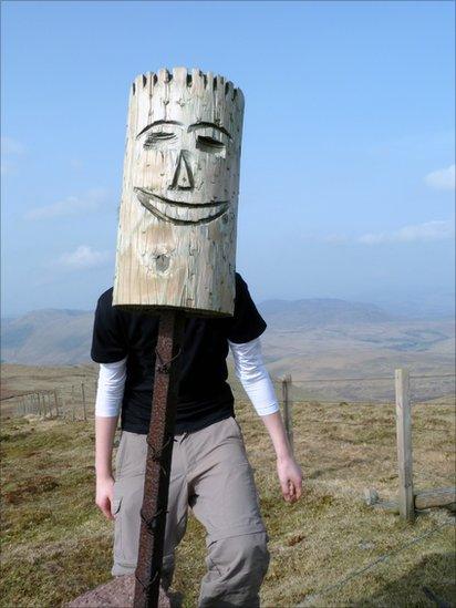 Grant posing behind a carved wooden post