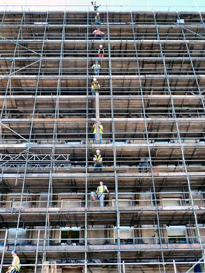 Workers putting up scaffolding