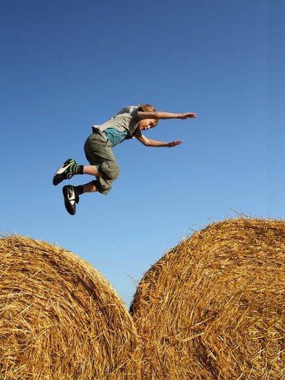 Ethan jumping on hay bales