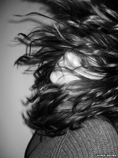 Woman's face obscured by hair