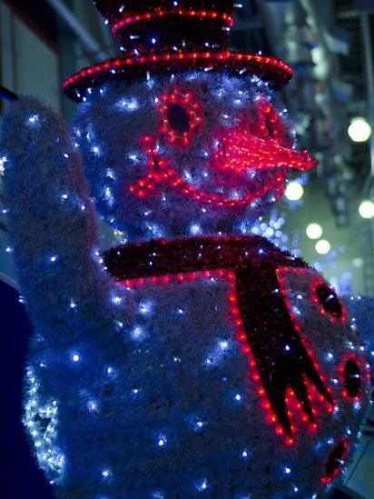 Snowman covered in festive lights