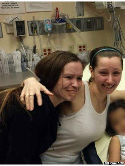 Amanda Berry (right) is reunited with her sister (left) in hospital in Cleveland, 7 May 2013