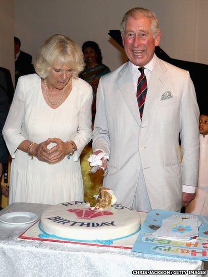 Britain's Prince Charles cuts a birthday cake during a visit to News  Photo - Getty Images