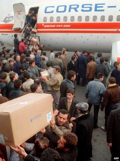 Unidentified helpers unload medical supplies, on December 10, 1988, from the non-governmental French humanitarian association 'Medecins du Monde'