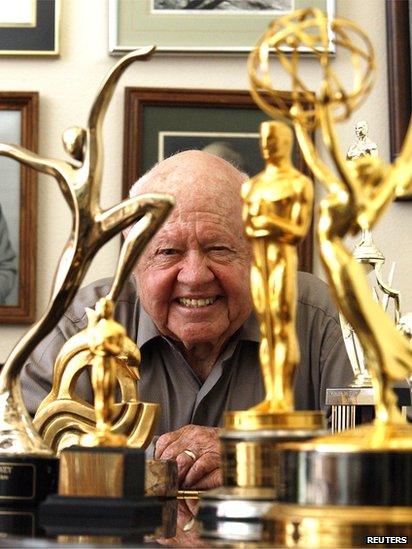 Actor Mickey Rooney smiles in front of his trophies at his home in Westlake Village, California in this 2007 file picture