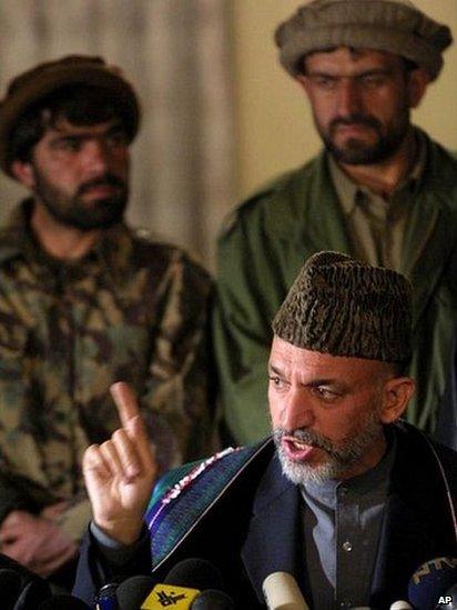 Newly-sworn in Afghan Prime Minister Hamid Karzai gestures while responding to a question from a member of the media, at a news conference, in the Afghan capital Kabul, Saturday, Dec. 22, 2001.