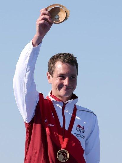 Gold medallist Alistair Brownlee holds up his quaich