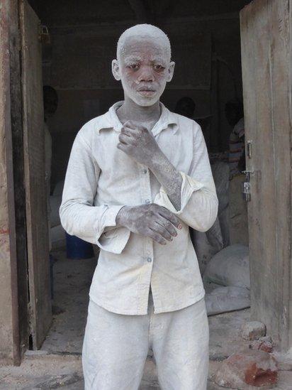 A man covered in dust from a mill