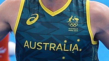 A close-up of the Australia badge and name on the vest of a men's hockey player