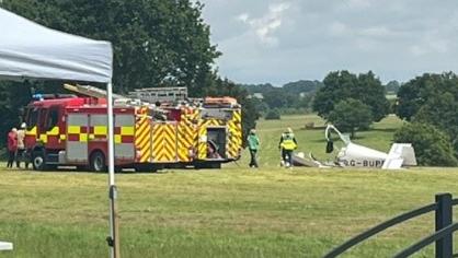 Two fire engines beside the wreckage of a light aircraft in the grounds of Heveningham Hall