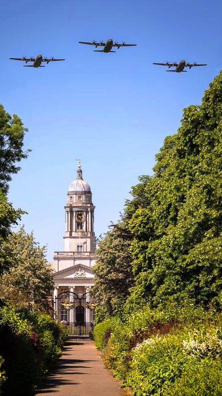 Three Hercules flying over the clocktower at RAF College Cranwell