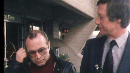 Bob Hoskins and Barry Norman walking along London's South Bank.