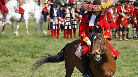 a Battle of the Boyne reenactor in uniform, riding a horse