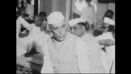 Black and white image of Jawaharial Nehru wearing a smart cap in the Mahatma's style.