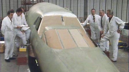 Concorde workers at Filton stand alongside an unfinished Concorde nosecone