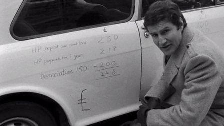 Nationwide presenter Jack Pizzey doing sums on the bodywork of a car.