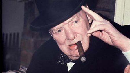 winston churchill smoking a large cigar, acknowledges a photographer.