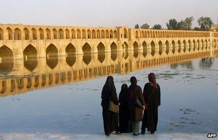 Iranian women look at the Si-o-Se Pol bridge in Isfahan, Iran (13 July 2002).