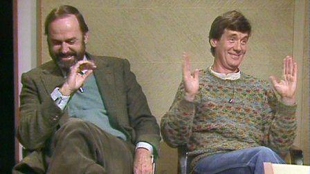 John Cleese laughing alongside a grinning Michael Palin in the Film 82 studio.