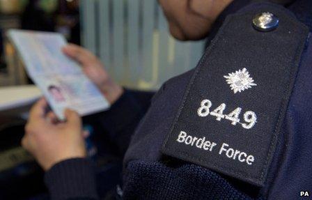 File image of a Border Force officer checking passports at Heathrow Airport's Terminal 2