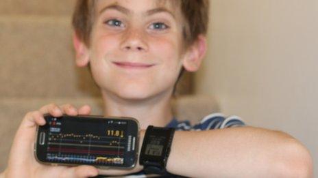 George with his T1 diabetes measurements on phone/smartwatch