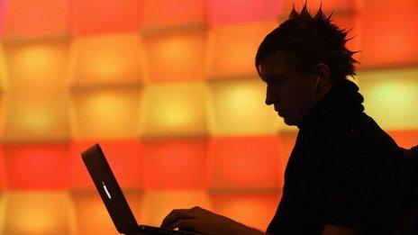silhouette of man at laptop