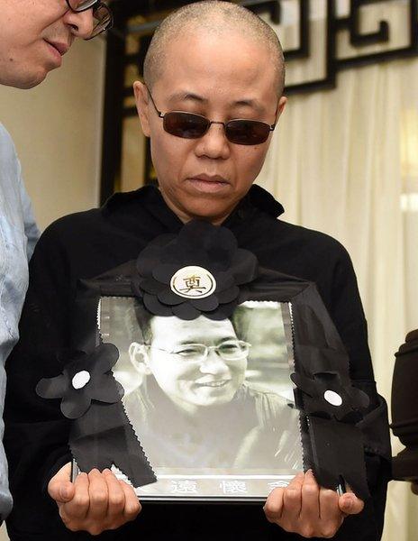 Liu Xia (C) holding a portrait of Liu Xiaobo in Shenyang, Liaoning province, on July 15, 2017