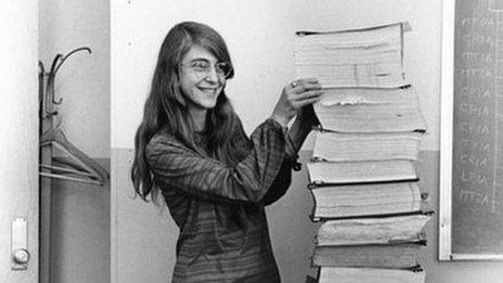 Margaret Hamilton with a stack of code