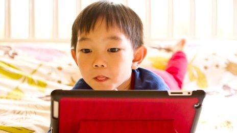 young child using tablet
