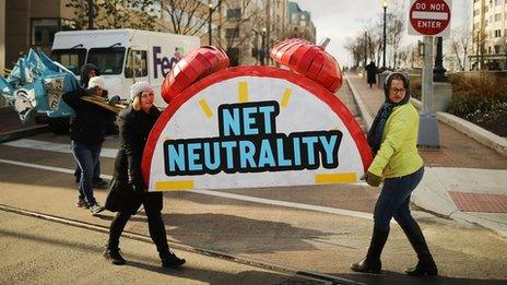 women carrying a net neutrality sign