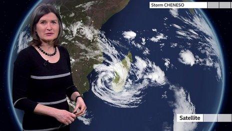 Helen Willetts stands in front of a weather map of Madagascar