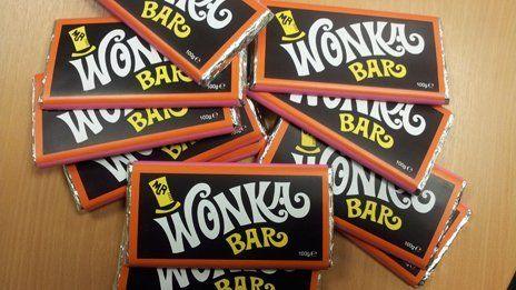 Nine orange and black chocolate bars with "Wonka Bar" logo