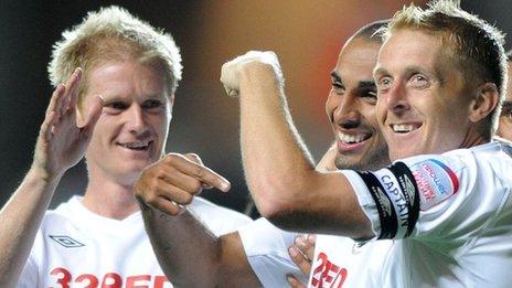 Alan Tate (L) celebrates with Darren Pratley and Garry Monk in 2010 against Coventry