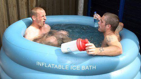 Two men sitting in a blue inflatable pool